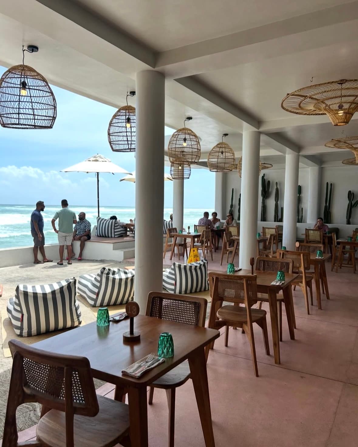 Rattan lamps, cacti and bean bags facing the ocean at Cactus